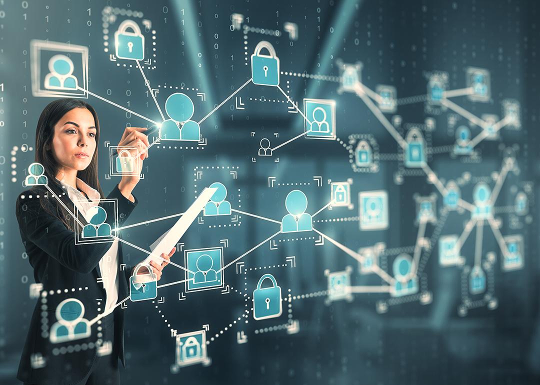 A businesswoman interacting with a 3D holographic network of people concept technology.