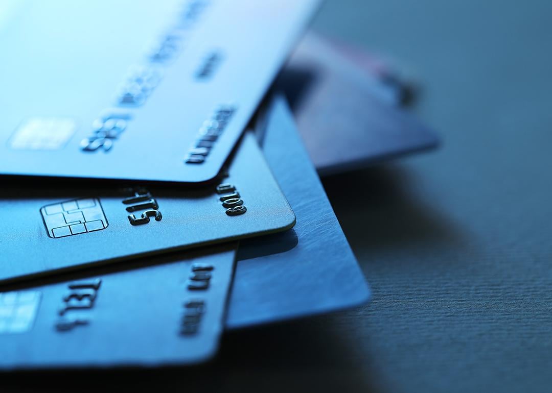 A stack of credit cards in dim light.