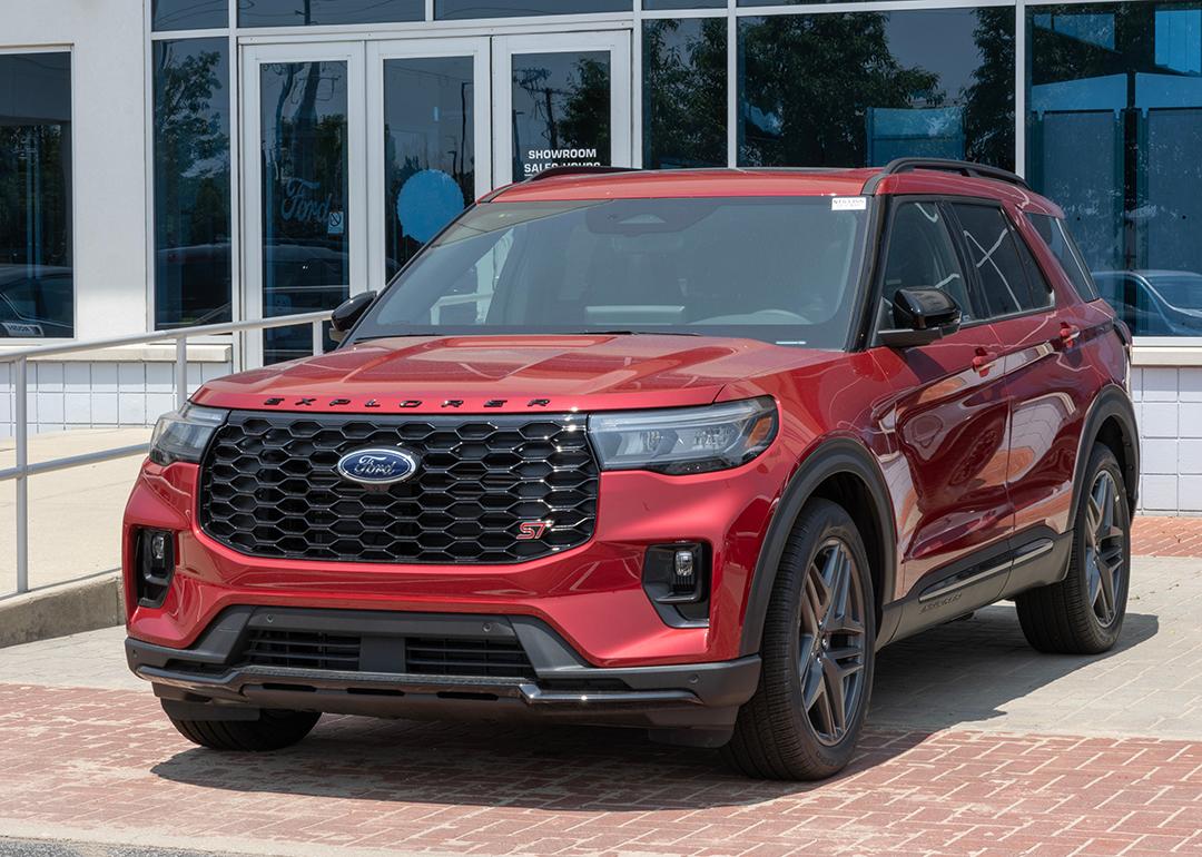 A red 2025 Ford Explorer ST AWD SUV displayed at a dealership.