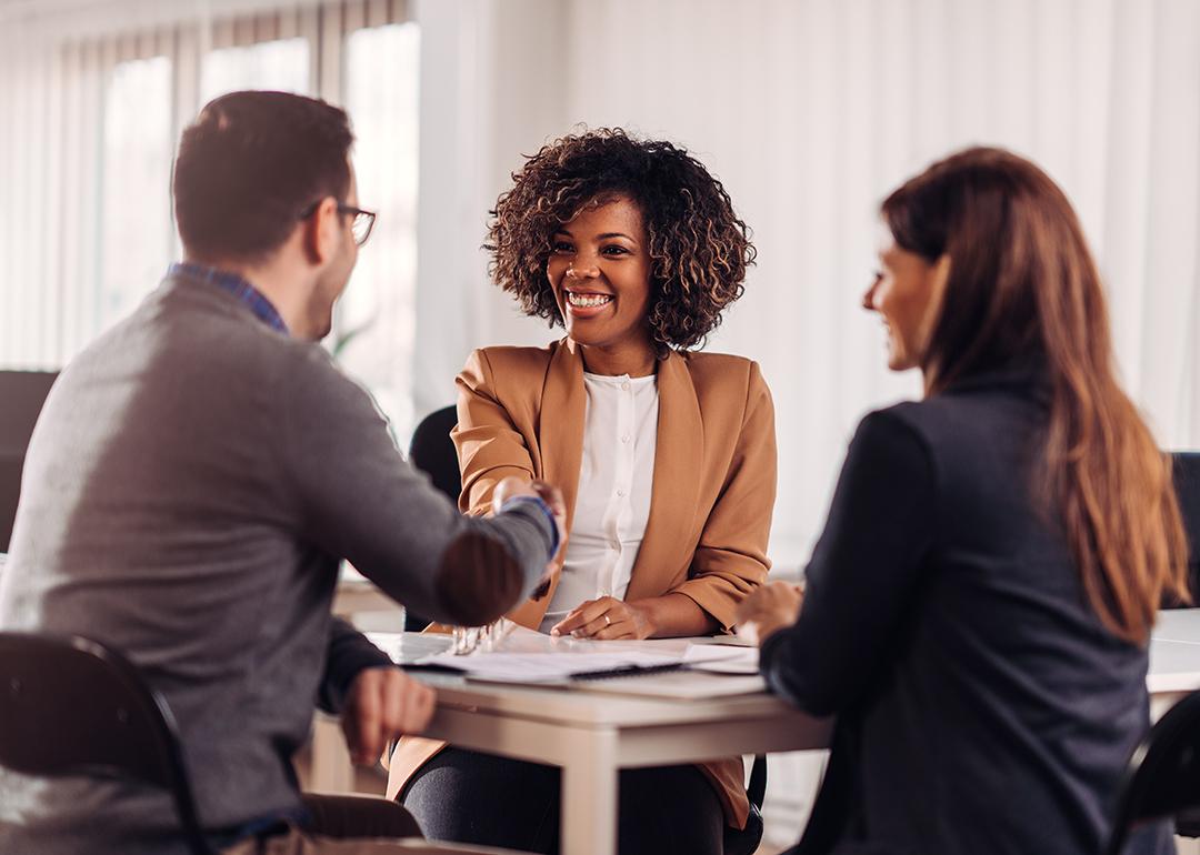 Business people shaking hands in a meeting.