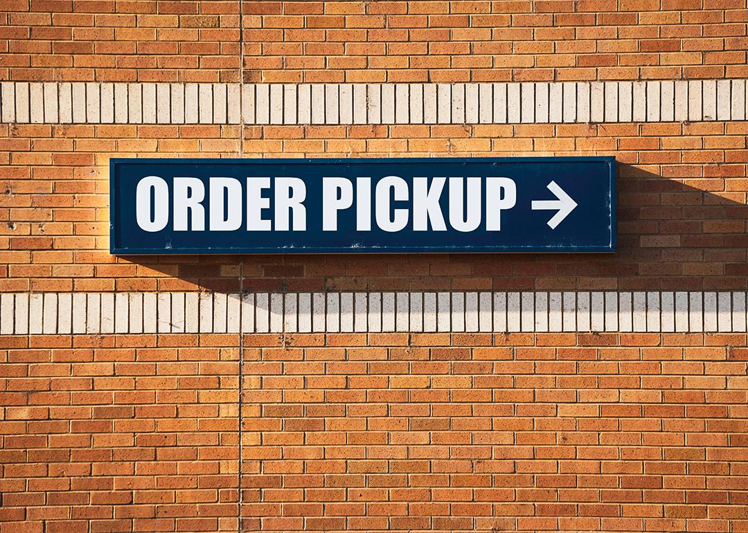 'Order pickup' sign pointing to the left at a store.