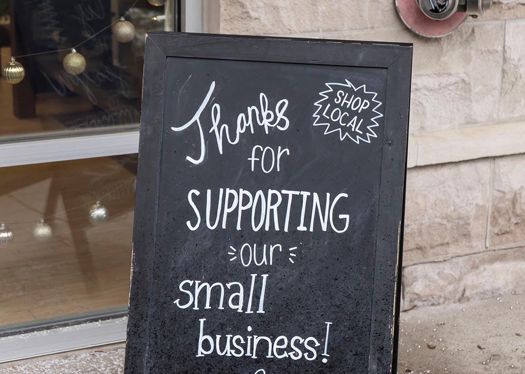 Small business chalkboard sign on sidewalk saying "Thanks for supporting our small business."