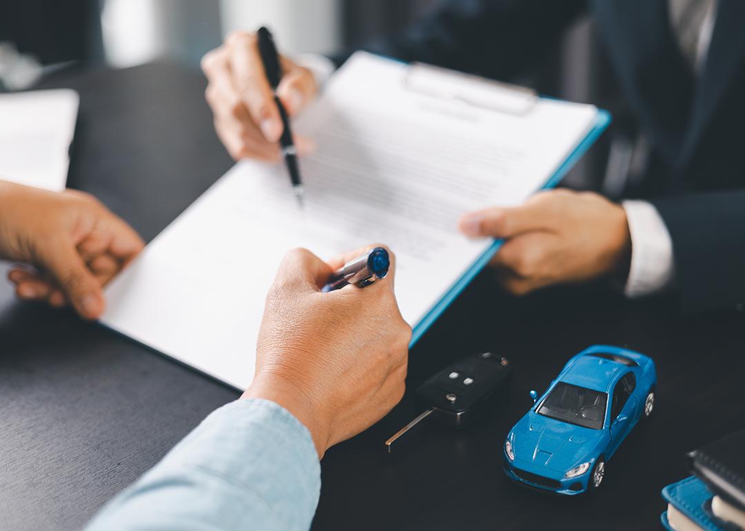 A customer signs a car purchase contract.