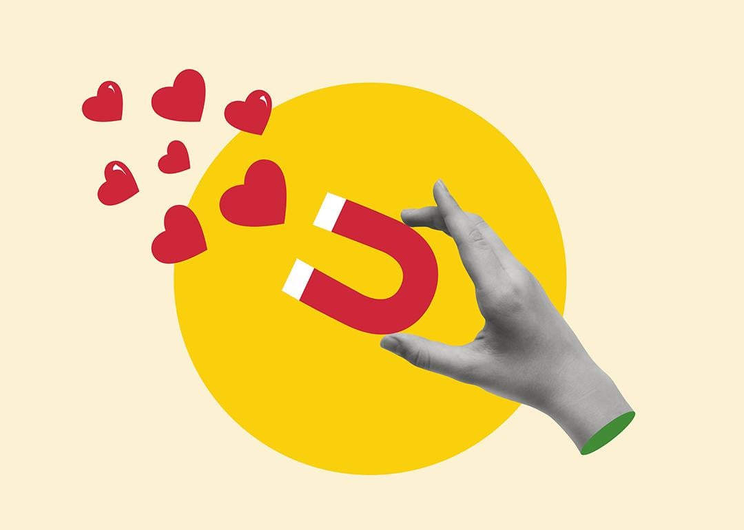 A custom illustration of a hand holding a magnet pulling hearts.
