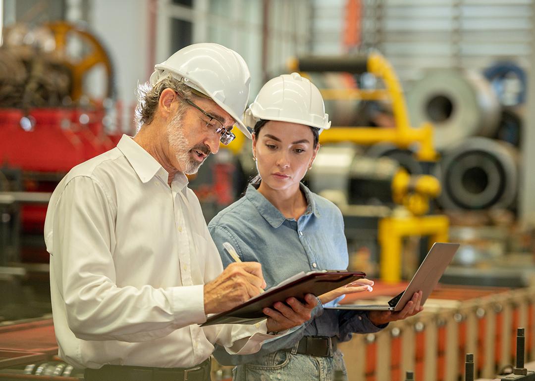 Engineers in an industrial factory conducting machine inspection.