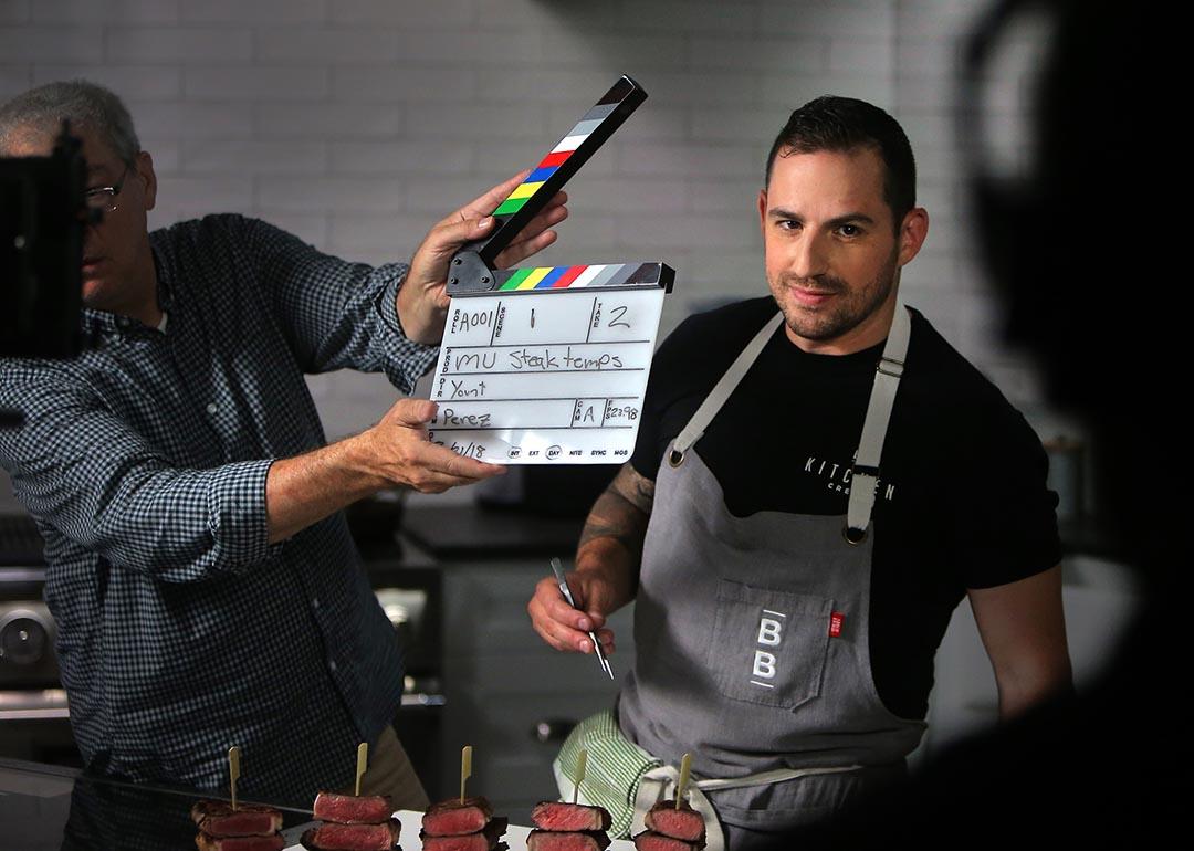 Yankel Polak, ButcherBox head chef, smiles while director and cinematographer Scot Yount snaps a slate at ButcherBox in Peabody, MA on Aug. 22, 2018. ButcherBox is a subscription based service for grass-fed beef - as well as humanely-raised pork and chicken.
