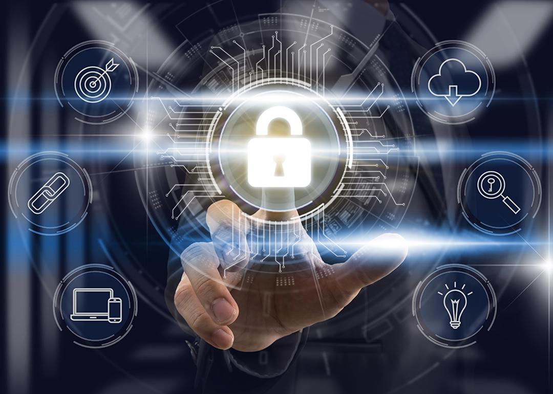 A businessperson touching a lock icon as part of a cybersecurity technology software graphic.