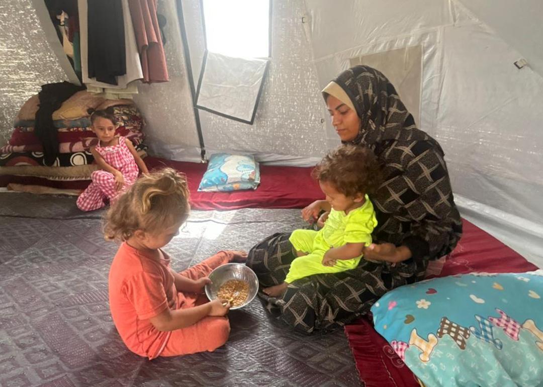 Recently widowed single mother, Noura Abu Dan, with her small children in a refugee camp on Sheikh Mohammed Ahmed.