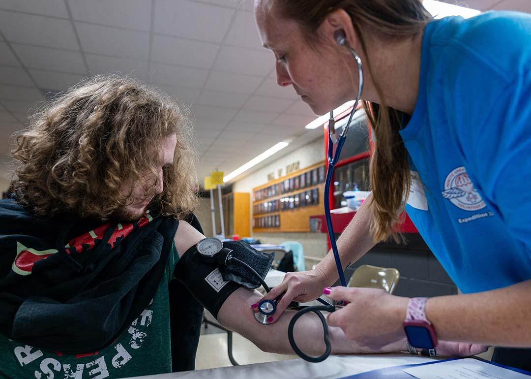 A high school student getting his blood pressure checked at a mobile medical clinic in Terre Haute South High School, Indiana.