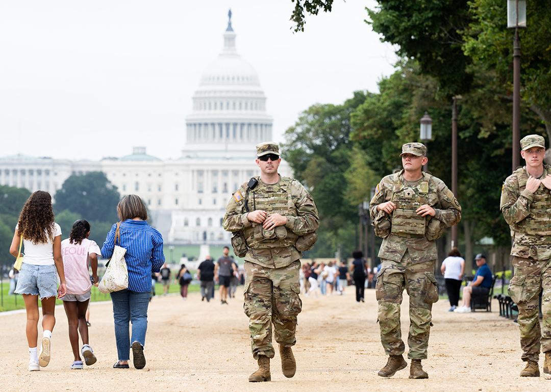 Members of the National Guard walking among civilians as part of their patrolling near the US Capitol area in Washington, DC.