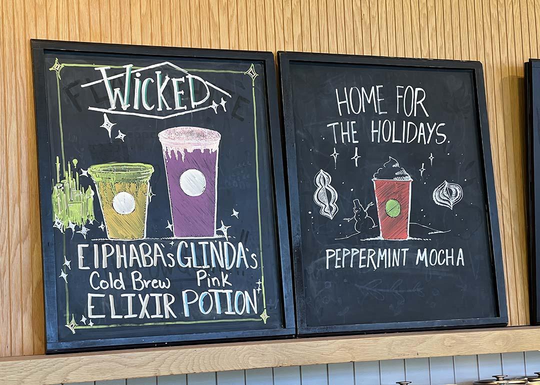 A chalkboard menu featuring Wicked x Starbucks' collaboration drinks.