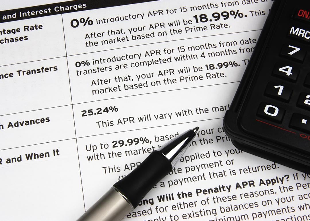 A pen and calculator on top of a credit terms report.