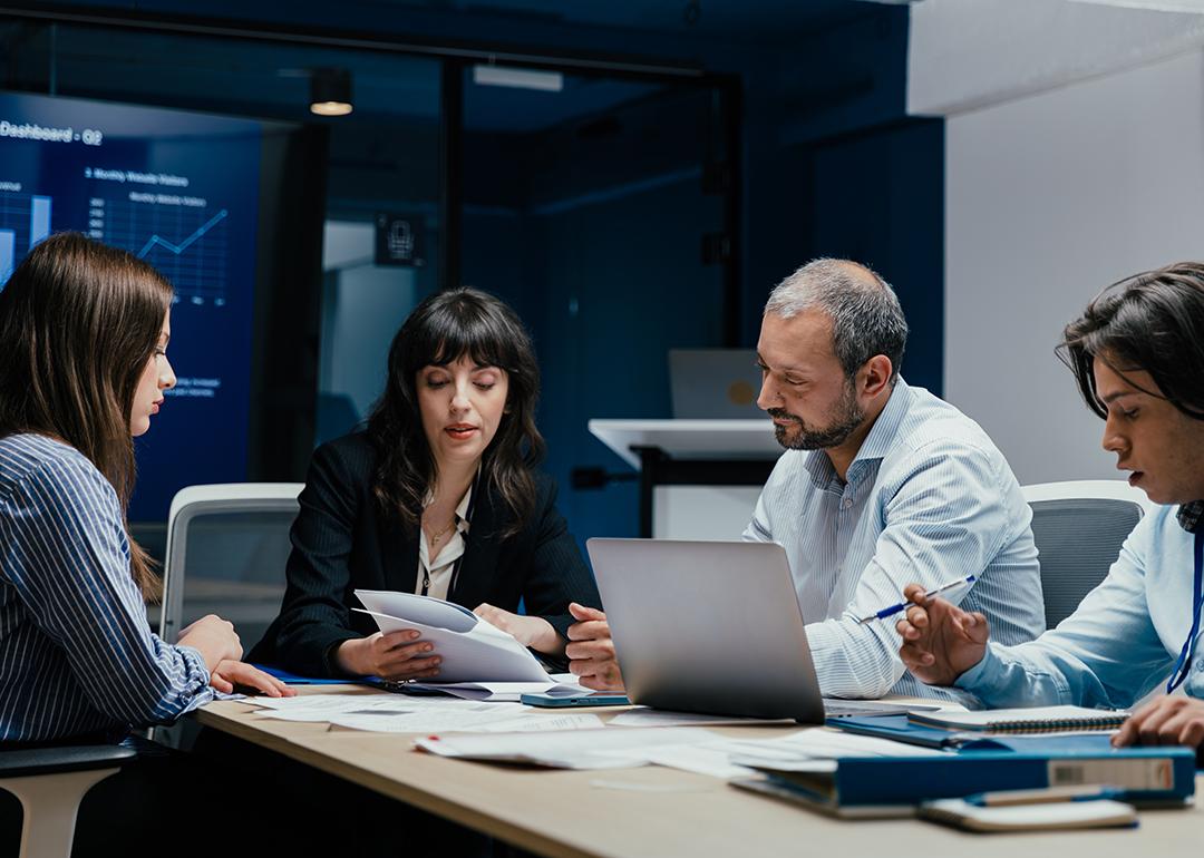 A group of business executives brainstorming in a boardroom.