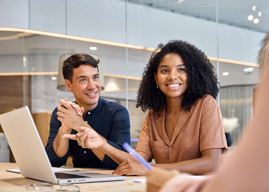 Professional employees discussing a project in their office.