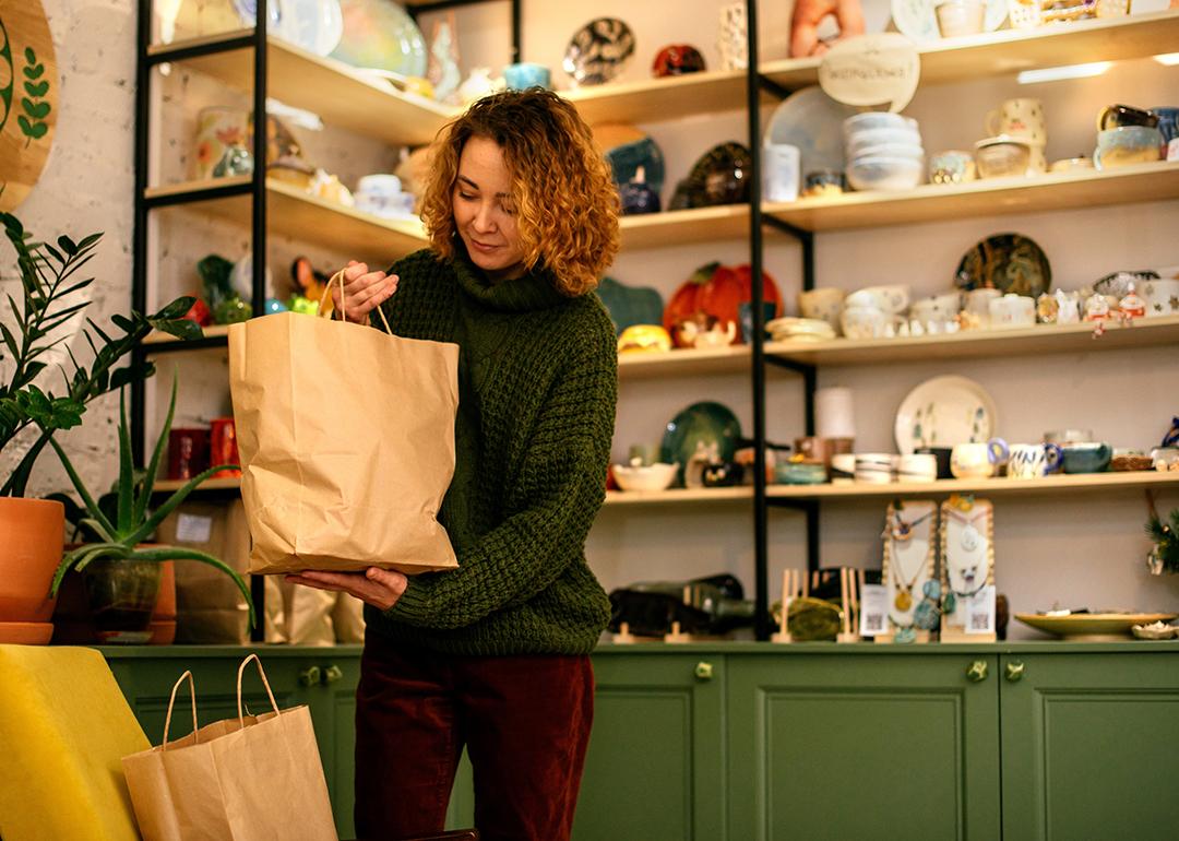 A woman packing sustainable gift items for Christmas.