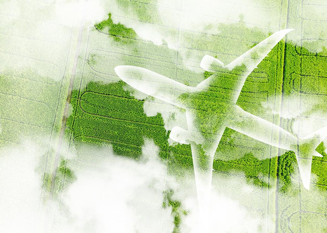 A figure of an airplane over a green field as a concept of sustainable aviation.