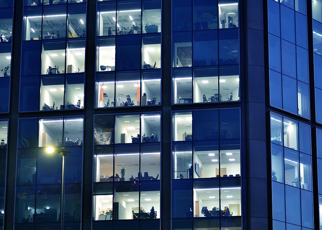 Glass facade of a modern corporate building during night.