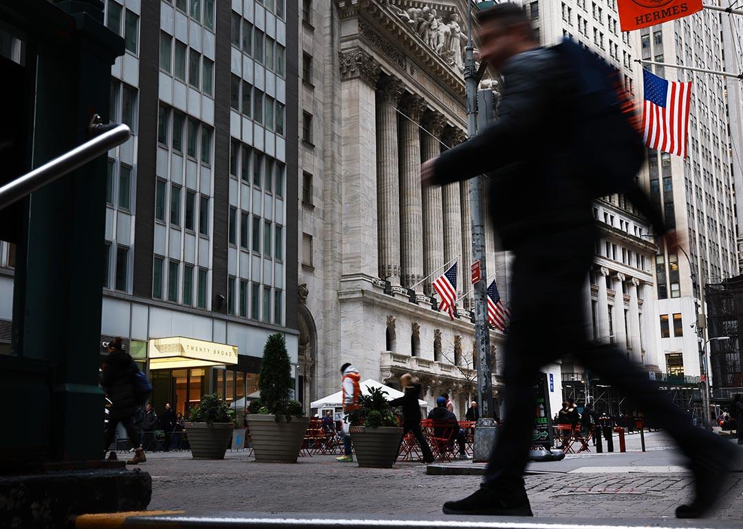 A blurred person in black clothing in the foreground walks past the New York Stock Exchange (NYSE) on November 20, 2025 in New York City. Stocks surged over 500 points after Nvidia on Wednesday reported fiscal third-quarter earnings that beat expectations.