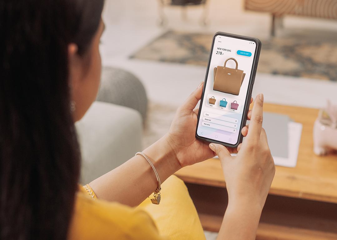 A woman browsing a shopping page on her smartphone.