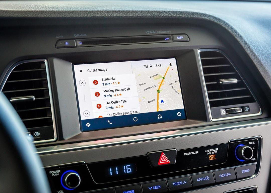 A 2017 Hyundai Sonata's dashboard displaying its GPS system and locations for nearby coffee shops.