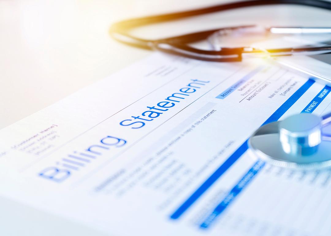 A close up on a healthcare billing statement document with a stethoscope on top.