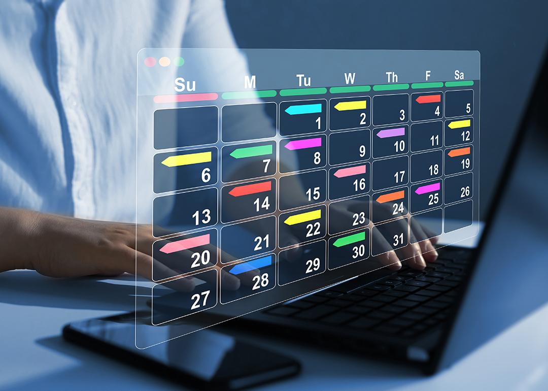 Person using a laptop with graphics of a digital calendar.