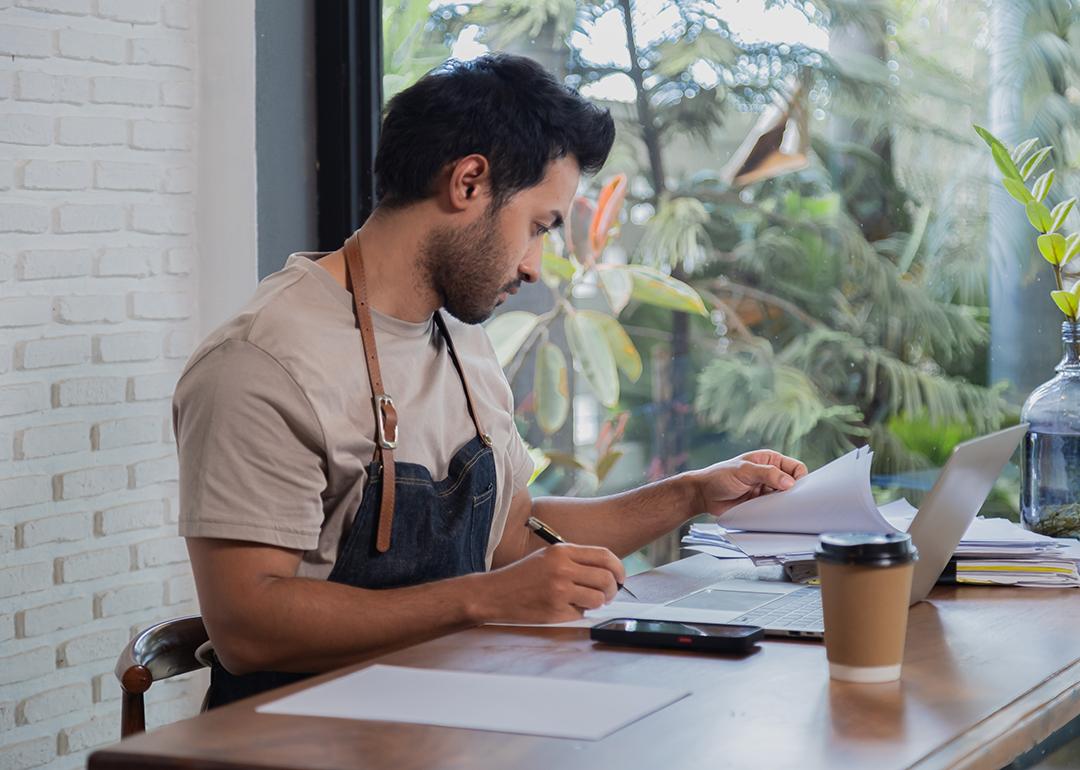 A small restaurant business owner working on tax documents.