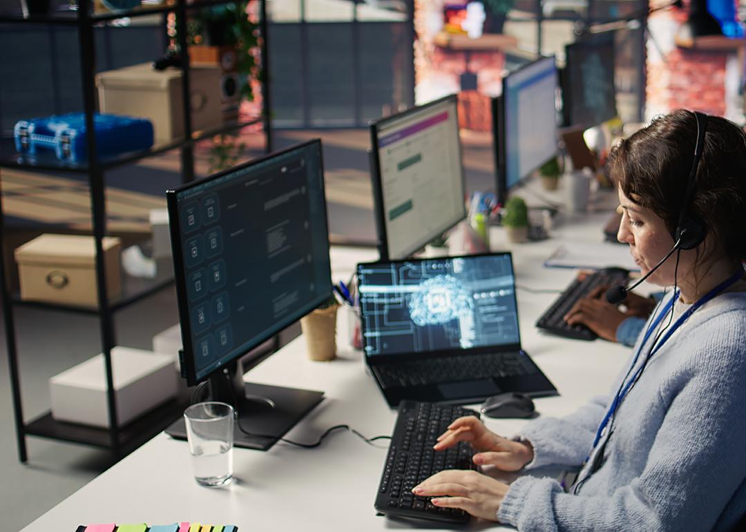 A female customer service worker using AI software to support operations.