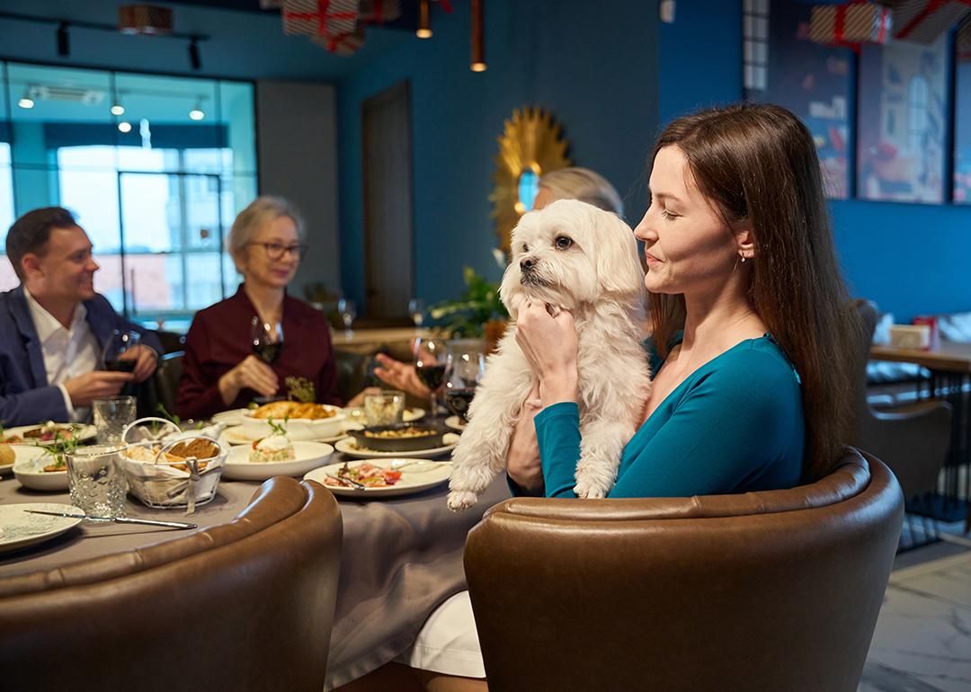 A woman holding her dog during family celebration of New Year's Eve.