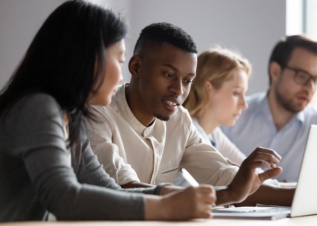 Colleagues seated at a desk in a co-working room.