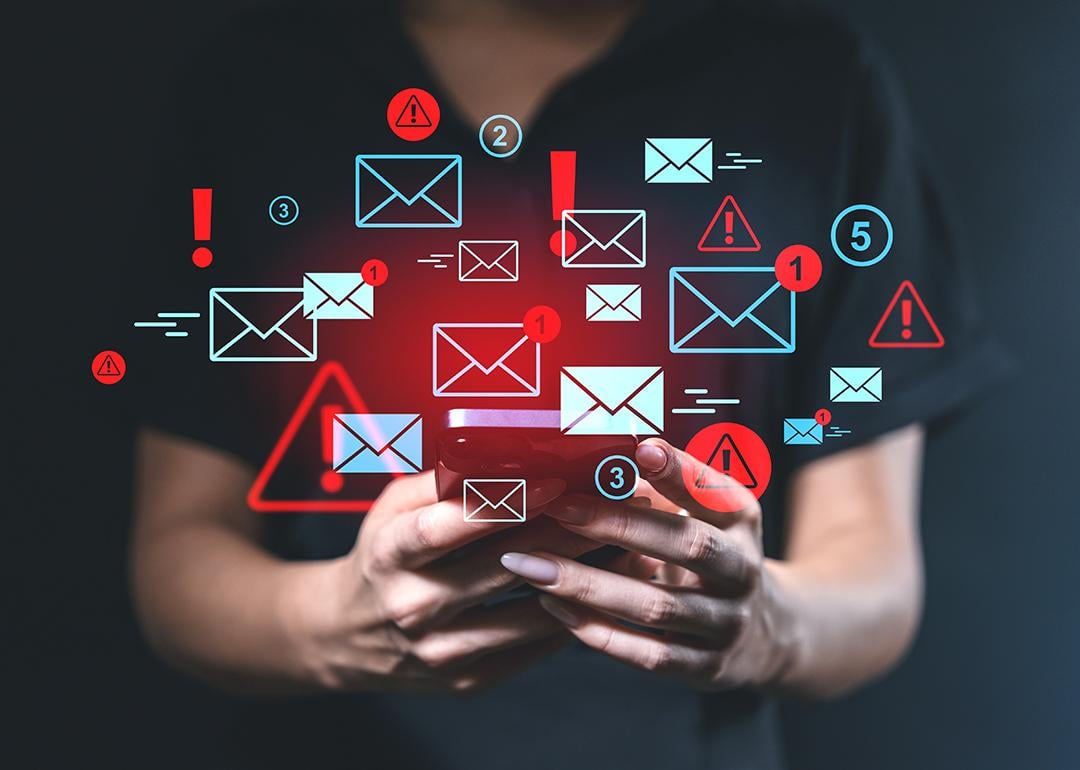 Person using a smartphone illustrated with blue and red email alert graphics.