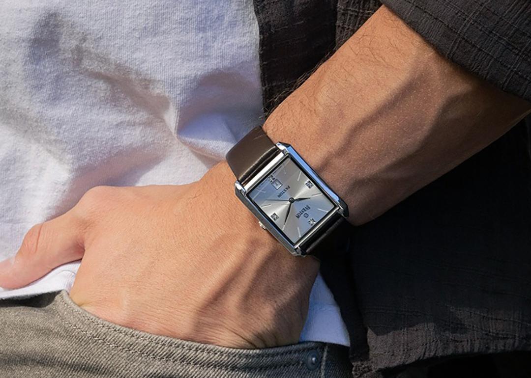 Close up on a man's wrist sporting a square watch.