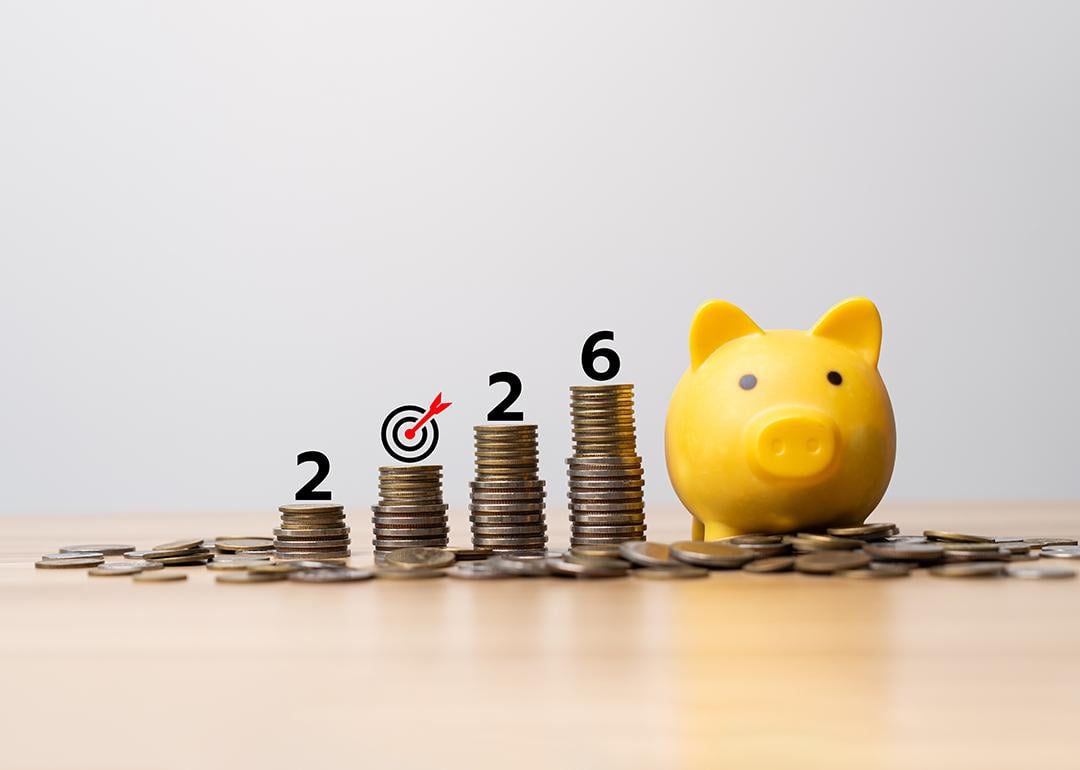 2026 target savings represented by a yellow piggy bank and a row of stacked coins.