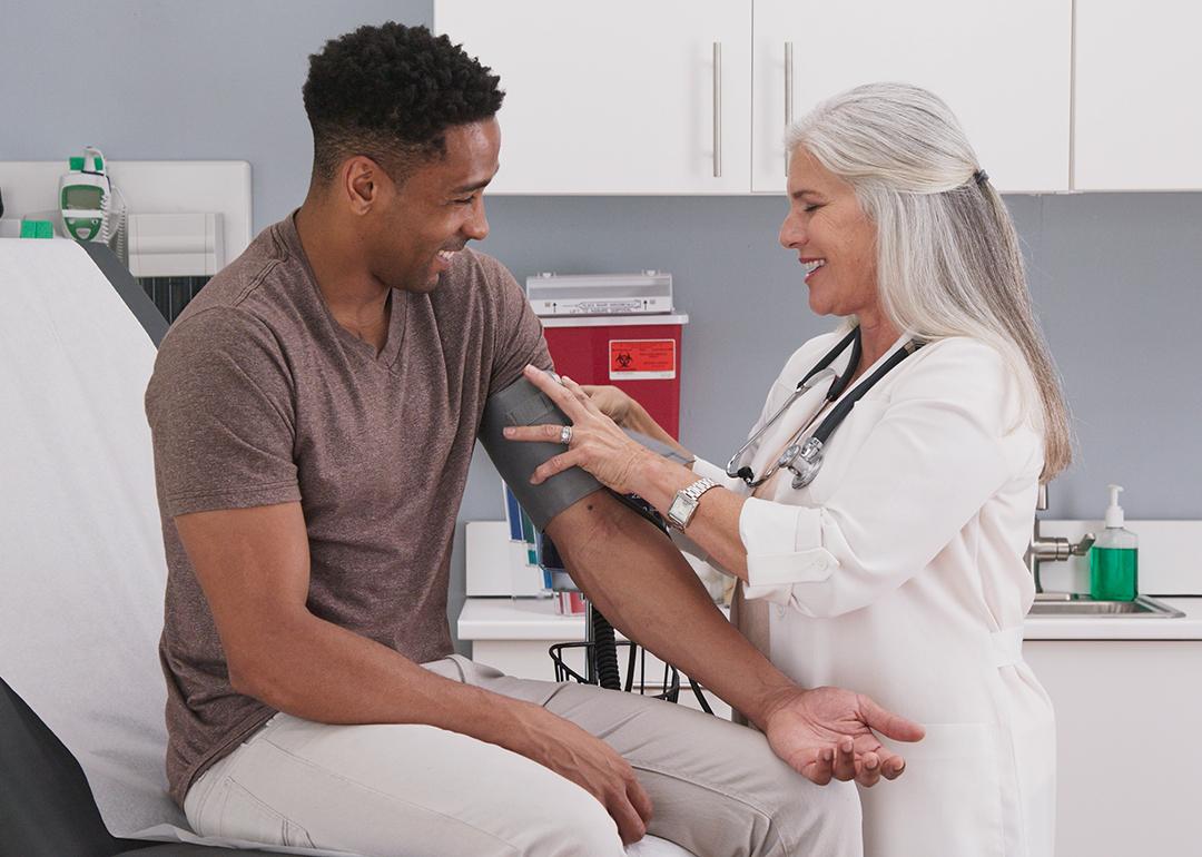 A physician checking her patient's blood pressure.