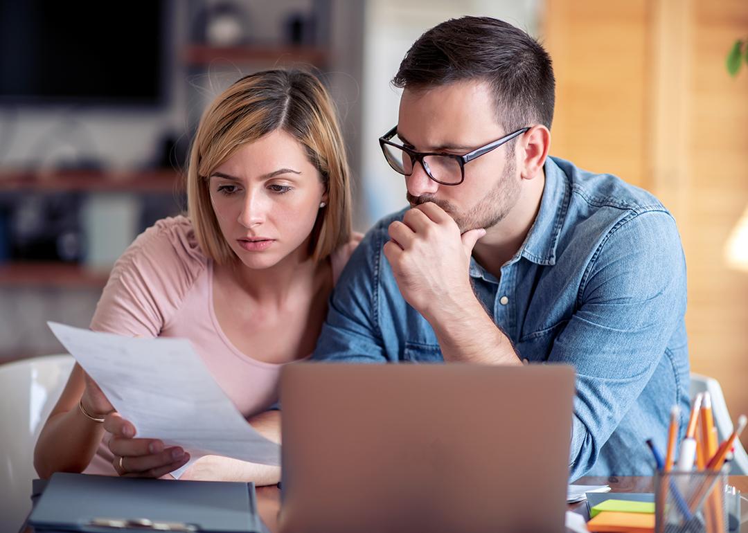 A couple analyzing finance documents.