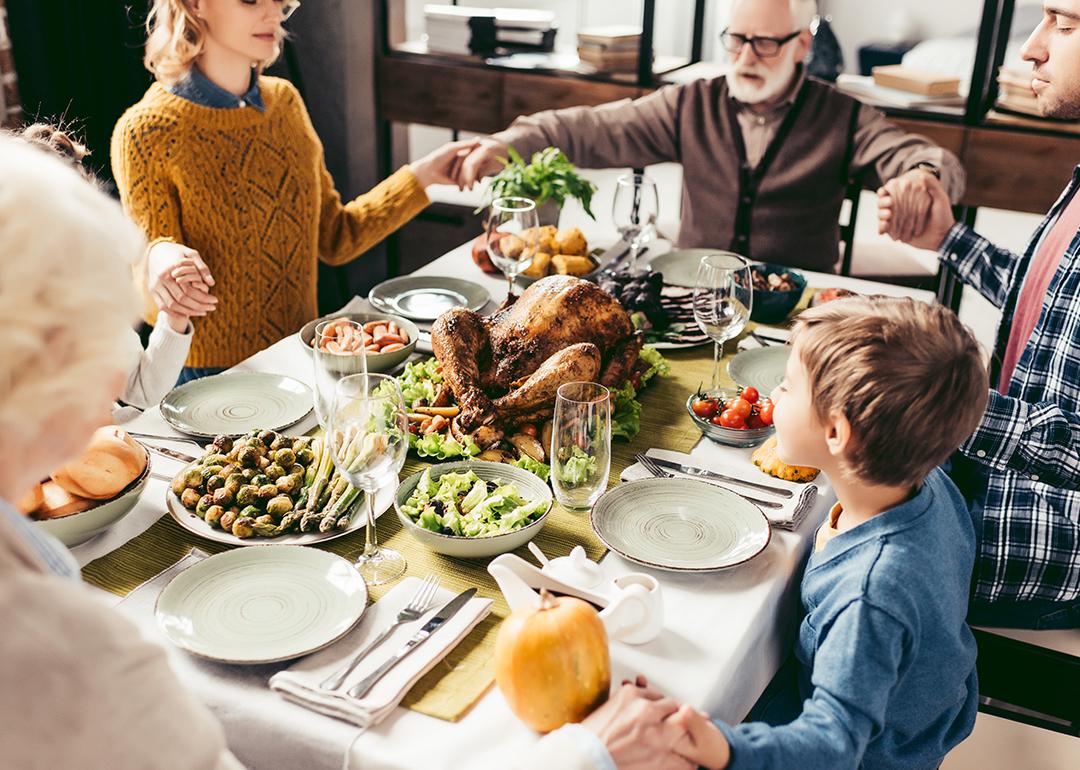 A family praying over their holiday dinner.