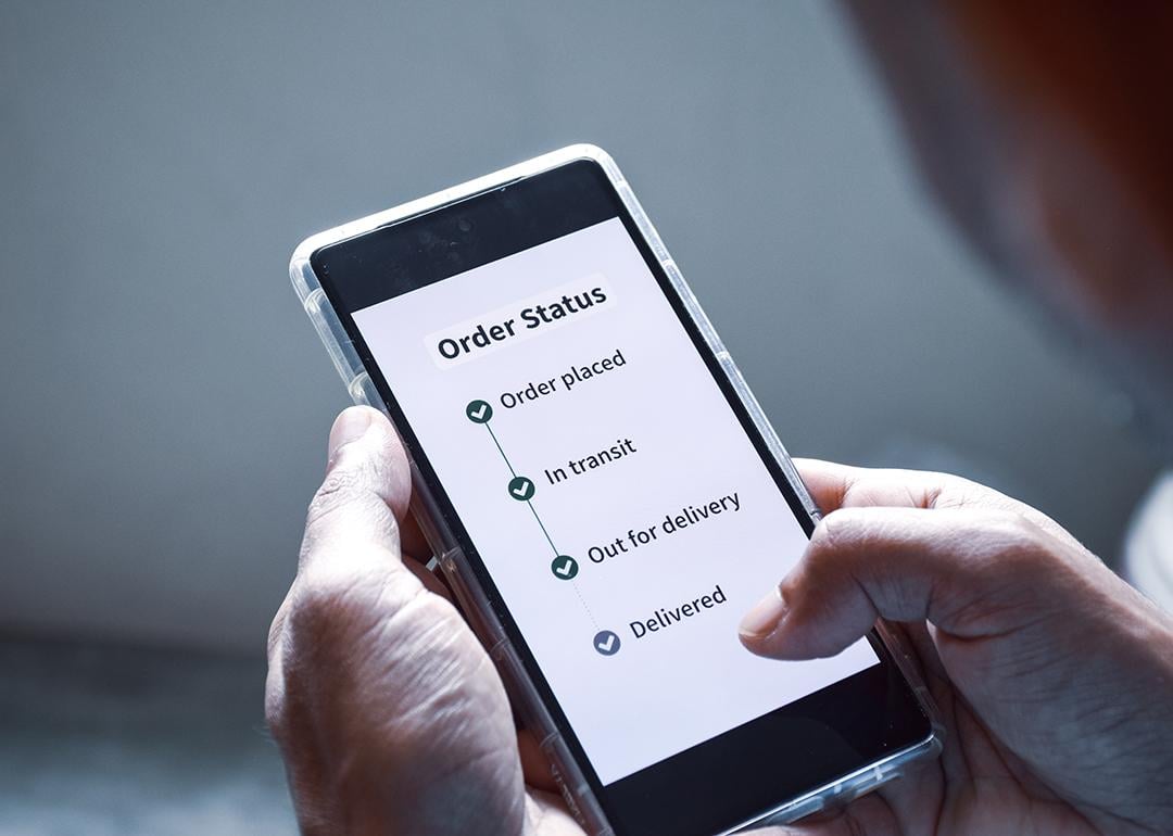 Person checking the order status of an item using smartphone.