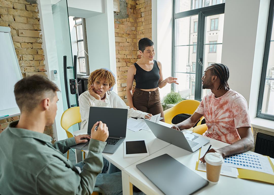 A diverse Gen Z business team in a meeting room.