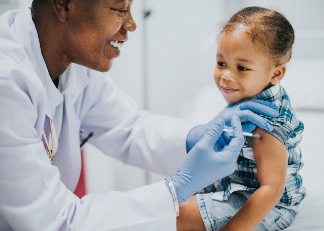 A pediatrician giving a toddler a vaccination.