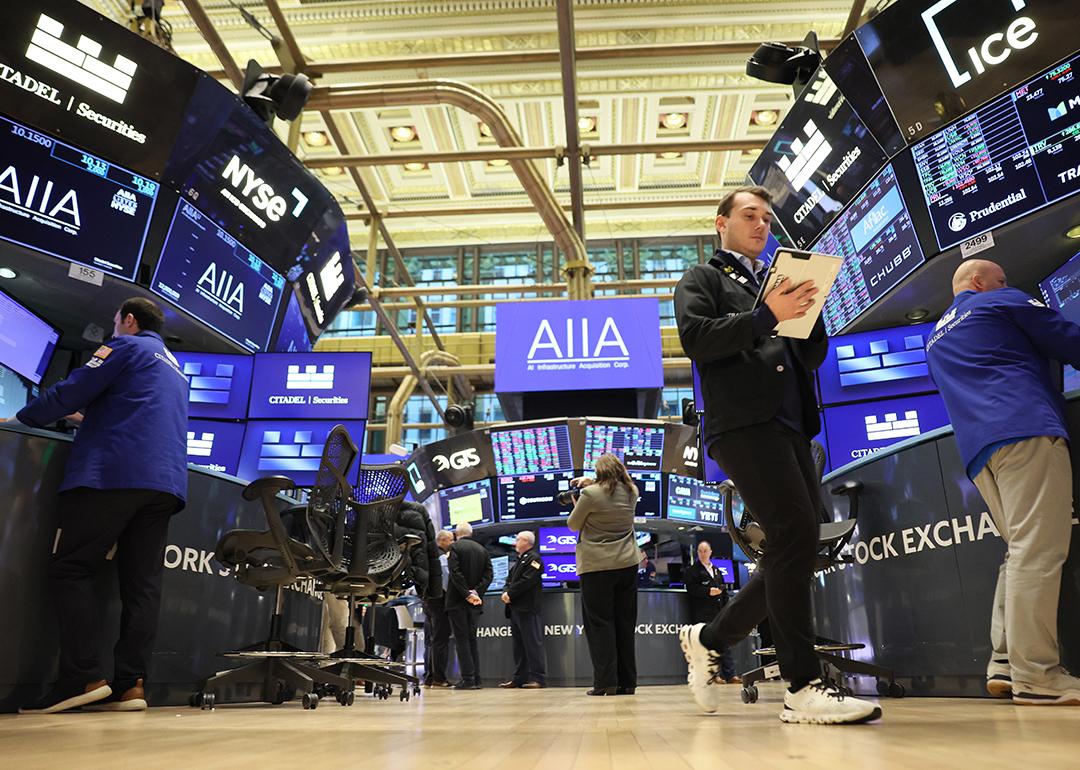 Traders work on the floor of the New York Stock Exchange during morning trading on November 19, 2025 in New York City.