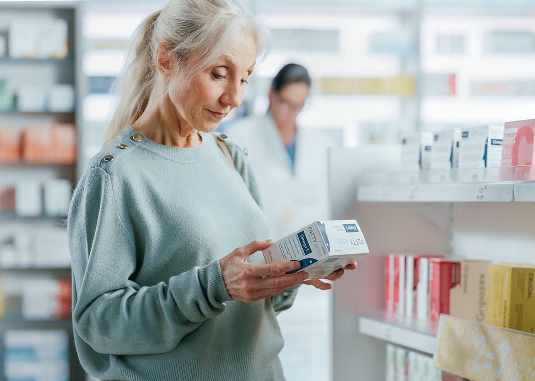 A senior woman buying a product at the pharmacy.