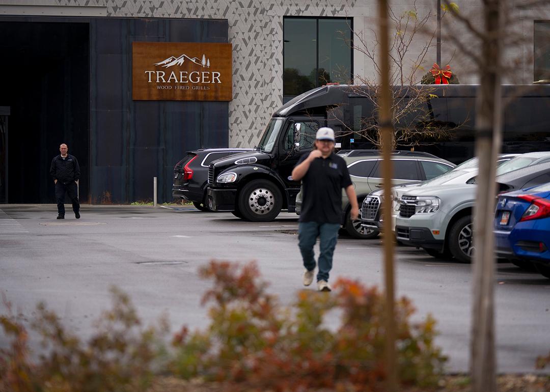 A person walking through the parking lot in the foreground with entrance to Traeger Grills Headquarters in behind, in Salt Lake City.
