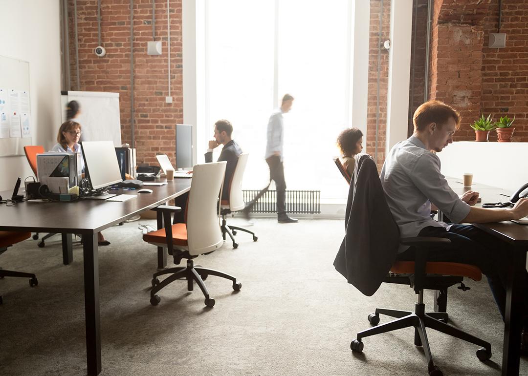 A busy team of employees around a modern office.