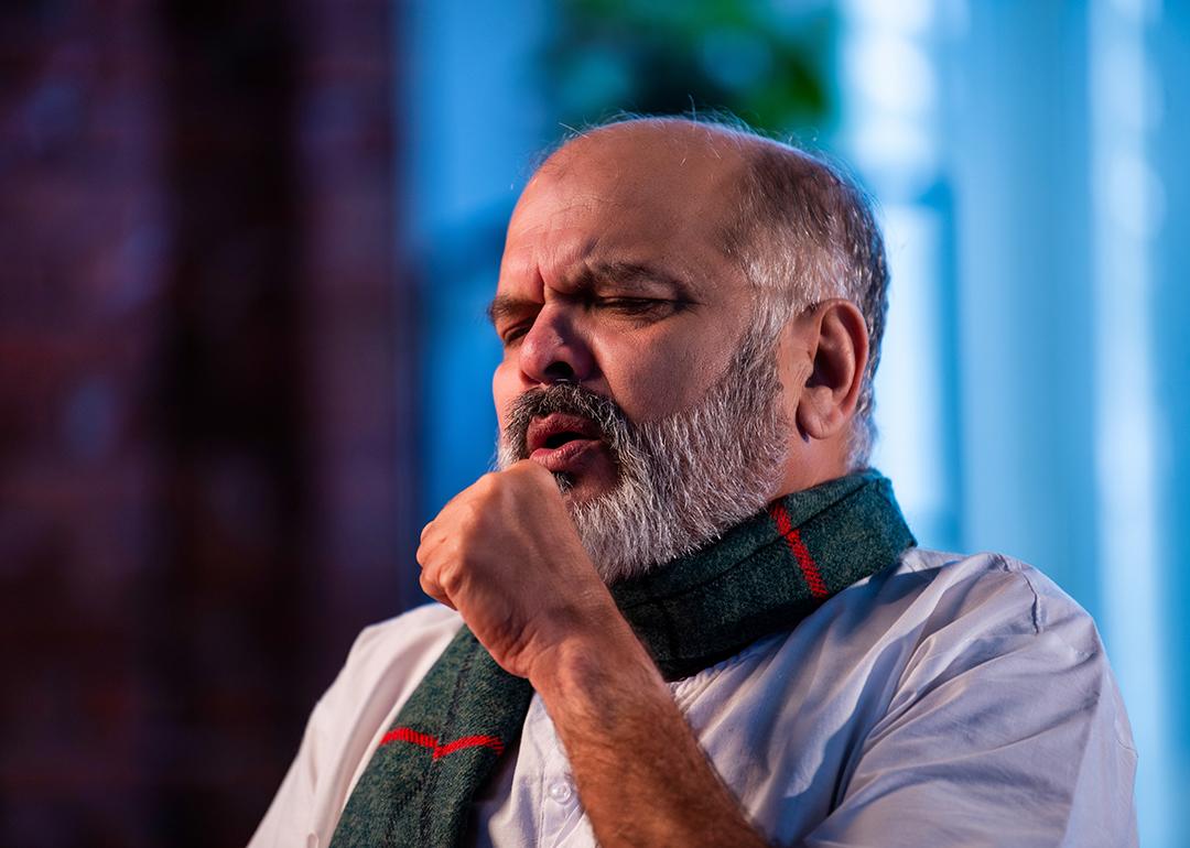 A senior man coughing.