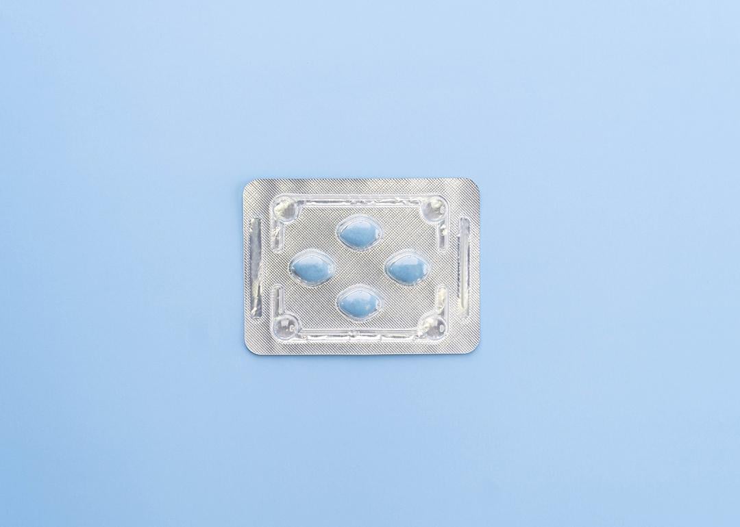A blister package of Sildenafil, also known as Viagra, on a blue background.