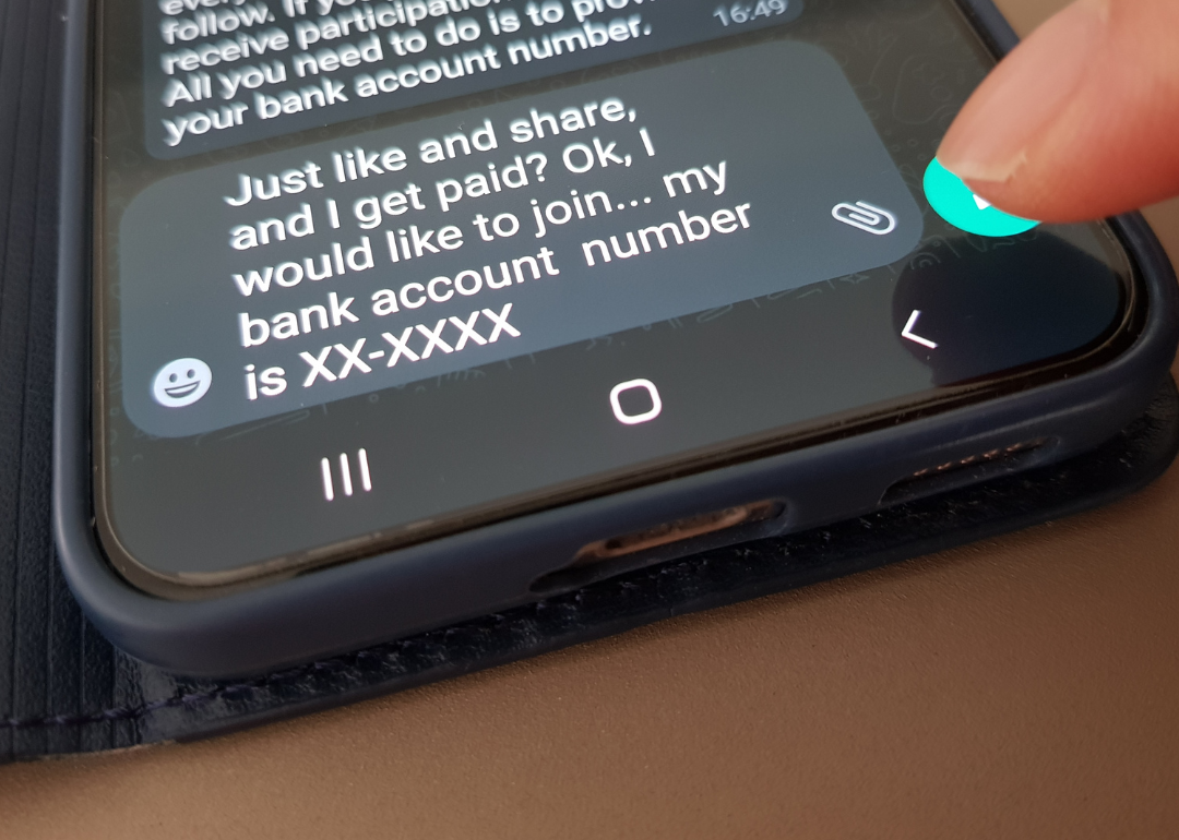 A person about to hit send to a message on their phone that says, "Just like share, and I get paid? Ok, I would like to join, my bank account number is XX-XXXX."