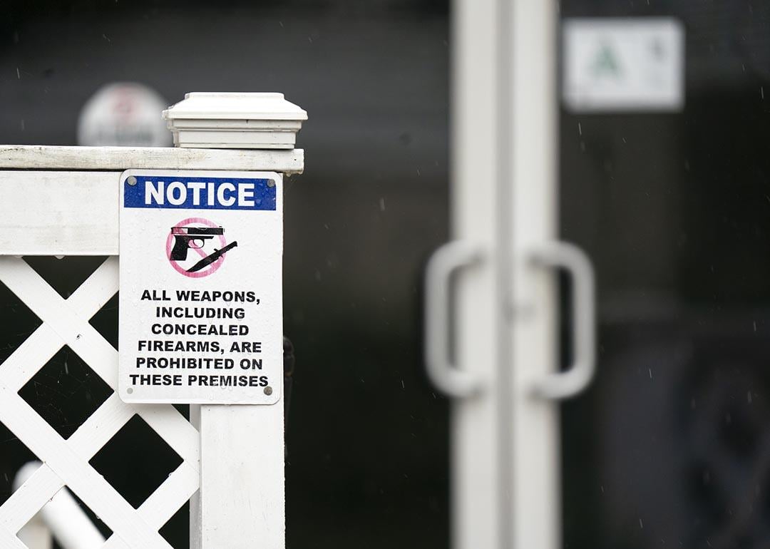 A sign prohibiting firearms at Willie's Bar & Grill posted on the fence outside in St. Helena Island, South Carolina. 