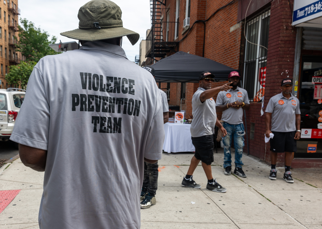 Members of a violence prevention team gather near a hookah lounge in New York City. 