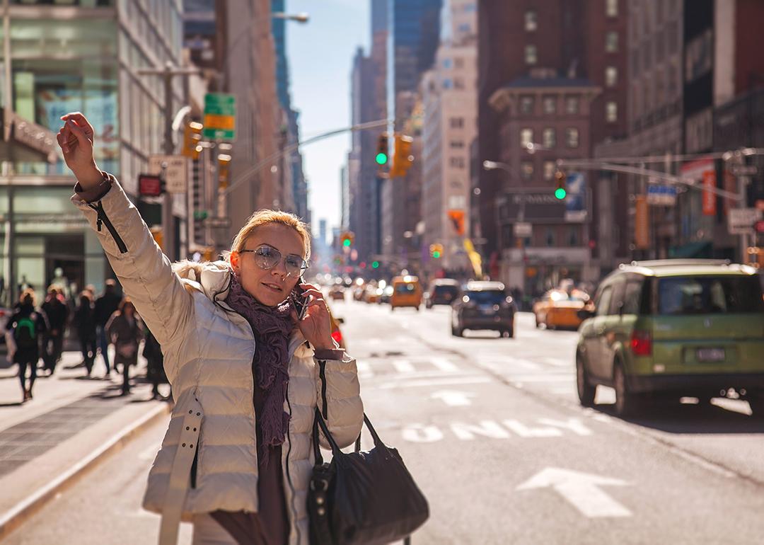Woman signaling for a cab in New York City. 