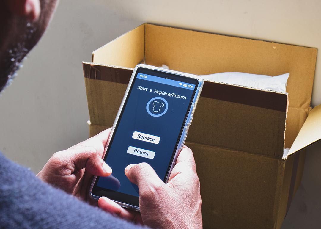 A man looking at a shopping app on his phone displaying options to replace or return a product.